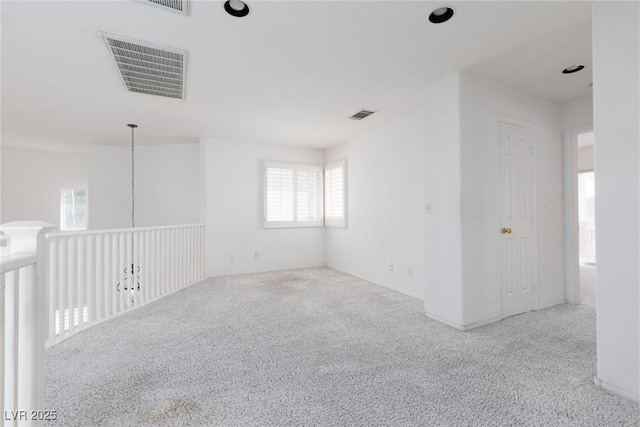 carpeted empty room with visible vents