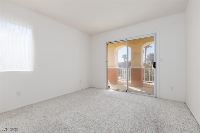 carpeted spare room featuring a healthy amount of sunlight
