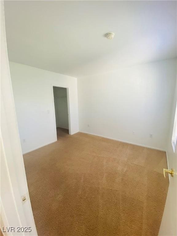 unfurnished room featuring light colored carpet