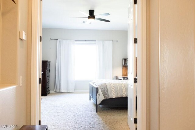 carpeted bedroom featuring a ceiling fan and baseboards