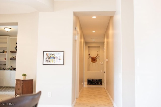 hall with baseboards, recessed lighting, and light tile patterned floors