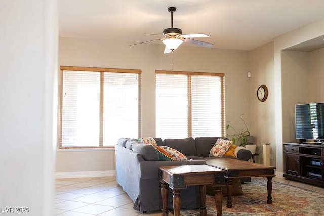 living room featuring ceiling fan, baseboards, and light tile patterned flooring