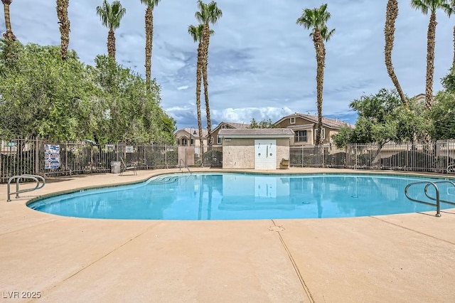 pool featuring fence and a patio