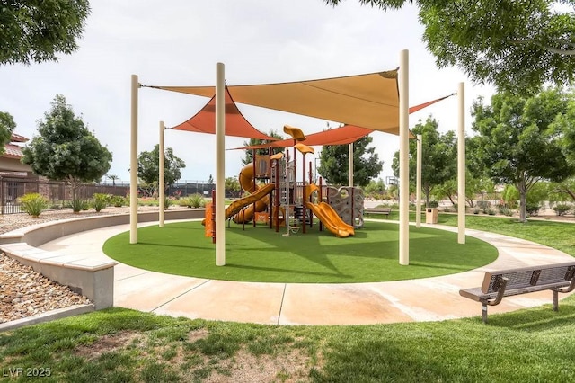 community jungle gym with a lawn and fence