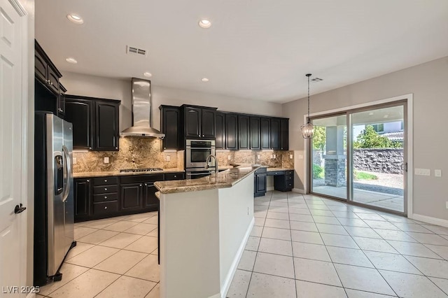 3908 Specula Wing Dr, North Las Vegas, NV 89084 - kitchen featuring stainless steel appliances, wall chimney range hood, light tile patterned floors, decorative backsplash, and light stone countertops