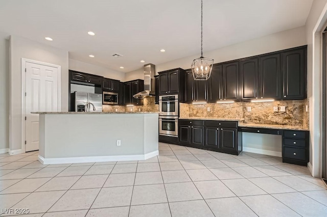 3908 Specula Wing Dr, North Las Vegas, NV 89084 - kitchen with appliances with stainless steel finishes, wall chimney range hood, a chandelier, backsplash, and recessed lighting