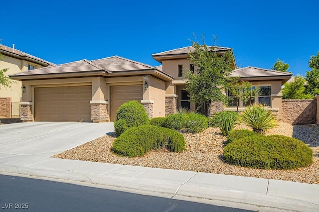 3908 Specula Wing Dr, North Las Vegas, NV 89084 - view of front of property with stucco siding, a garage, stone siding, concrete driveway, and a tiled roof