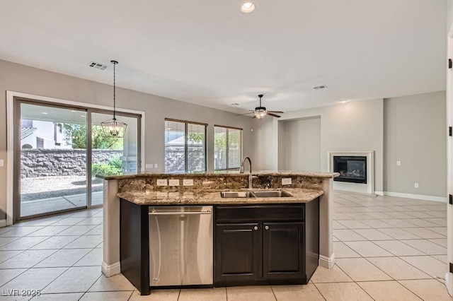 3908 Specula Wing Dr, North Las Vegas, NV 89084 - kitchen with open floor plan, light tile patterned flooring, light stone counters, a kitchen island with sink, and a ceiling fan