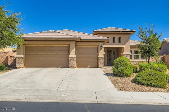 3908 Specula Wing Dr, North Las Vegas, NV 89084 - prairie-style house featuring an attached garage, stone siding, concrete driveway, and stucco siding