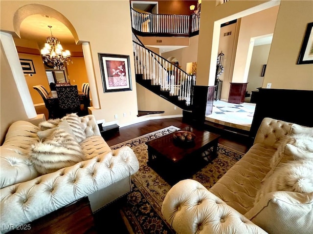 8690 W Ford Ave, Las Vegas, NV 89148 - living area with wood finished floors, stairway, a chandelier, arched walkways, and baseboards