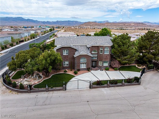 8690 W Ford Ave, Las Vegas, NV 89148 - view of front of property featuring a gate, a fenced front yard, a mountain view, and brick siding