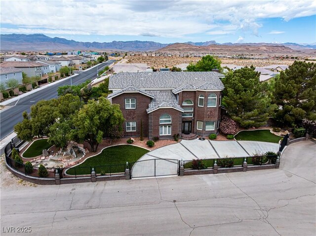 8690 W Ford Ave, Las Vegas, NV 89148 - view of front of property featuring a gate, a fenced front yard, a mountain view, and brick siding