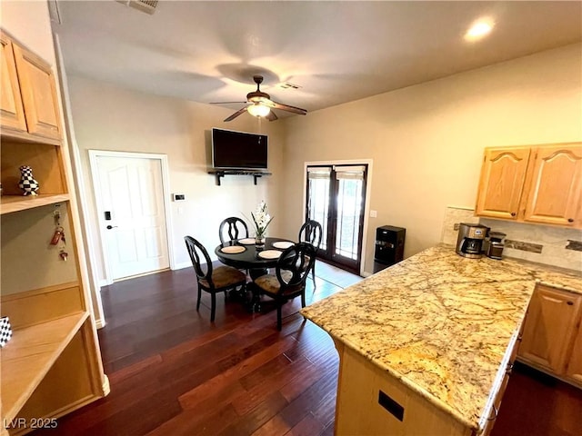 8690 W Ford Ave, Las Vegas, NV 89148 - kitchen featuring light brown cabinetry, a peninsula, a ceiling fan, dark wood-style floors, and light stone countertops