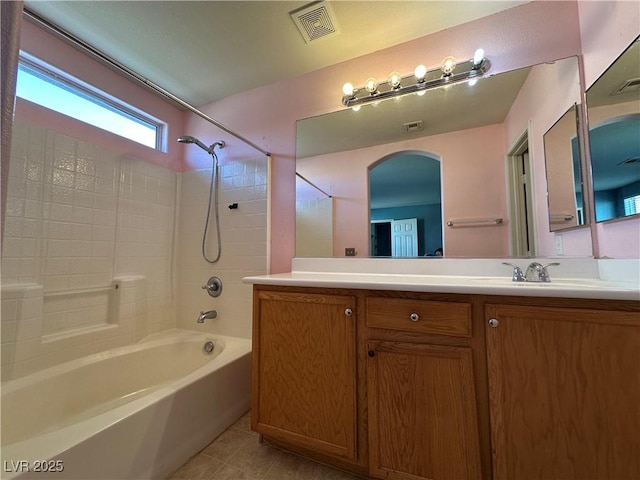 bathroom featuring tile patterned floors, vanity, shower / tub combination, and visible vents