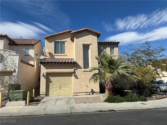 mediterranean / spanish-style home featuring a tiled roof, a garage, stucco siding, and driveway
