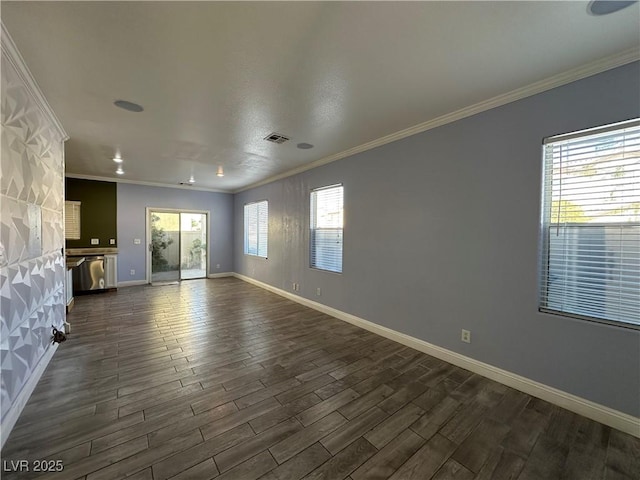 unfurnished living room with dark wood-type flooring, visible vents, baseboards, and ornamental molding
