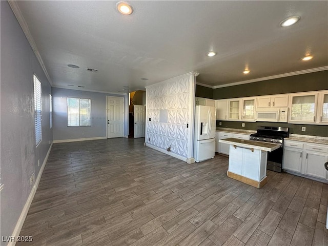 kitchen featuring a center island, open floor plan, white appliances, dark wood-style floors, and white cabinetry
