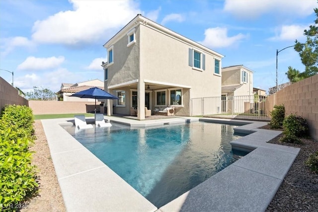 view of swimming pool featuring a fenced backyard, a patio, outdoor lounge area, and a ceiling fan