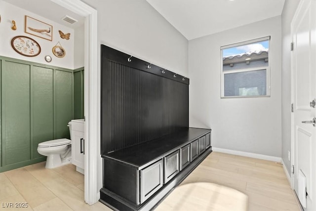 bathroom featuring wood finished floors and toilet