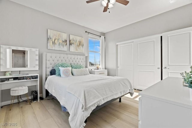 bedroom featuring light wood-style floors, a closet, and ceiling fan