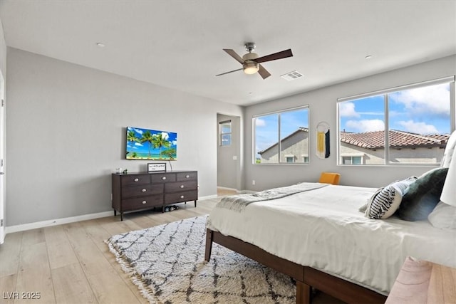 bedroom with baseboards, wood finished floors, and a ceiling fan
