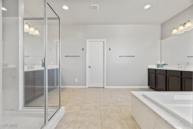 bathroom featuring vanity, tile patterned flooring, a bathtub, a shower with shower door, and baseboards