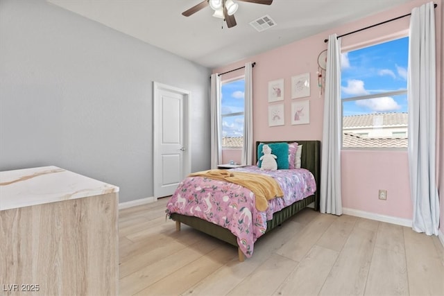 bedroom featuring light wood-style flooring, baseboards, and ceiling fan