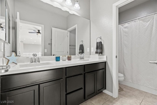 bathroom featuring double vanity, tile patterned flooring, toilet, a ceiling fan, and a shower with shower curtain