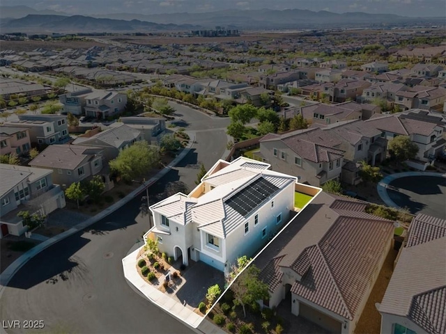 aerial view of residential area featuring a mountainous background and property boundaries highlighted
