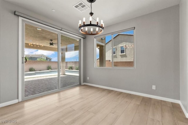 3062 Echoed Rondel Ln, Henderson, NV 89044 - empty room featuring a chandelier and wood finished floors