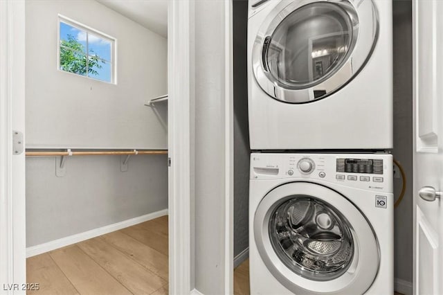 3062 Echoed Rondel Ln, Henderson, NV 89044 - laundry area featuring stacked washing machine and dryer and wood finished floors