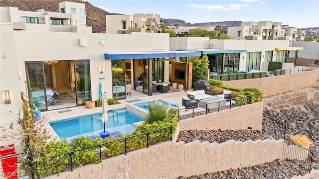 387 Solitude Peak Ln, Henderson, NV 89012 - rear view of house featuring an outdoor living space, a residential view, a patio area, a fenced in pool, and stucco siding