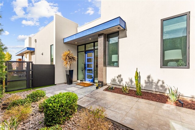 387 Solitude Peak Ln, Henderson, NV 89012 - property entrance with a gate, stucco siding, and fence