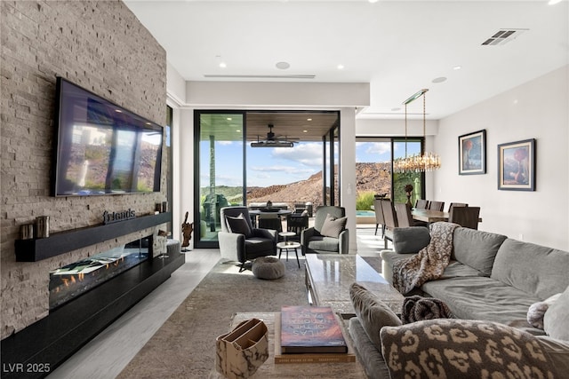 387 Solitude Peak Ln, Henderson, NV 89012 - living room with recessed lighting, visible vents, and an inviting chandelier
