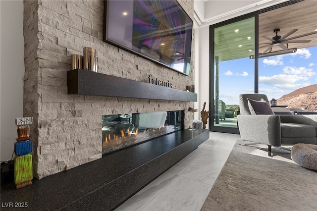 387 Solitude Peak Ln, Henderson, NV 89012 - living area featuring a ceiling fan, a multi sided fireplace, marble finish floor, and floor to ceiling windows