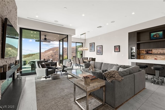 387 Solitude Peak Ln, Henderson, NV 89012 - living area featuring recessed lighting, a bar, a chandelier, and visible vents