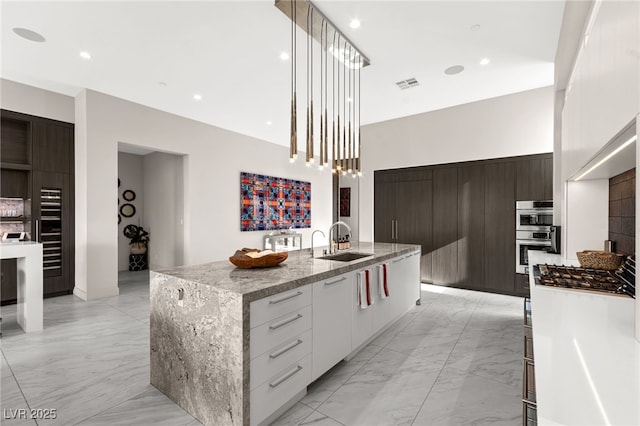 387 Solitude Peak Ln, Henderson, NV 89012 - kitchen with a sink, modern cabinets, visible vents, and marble finish floor