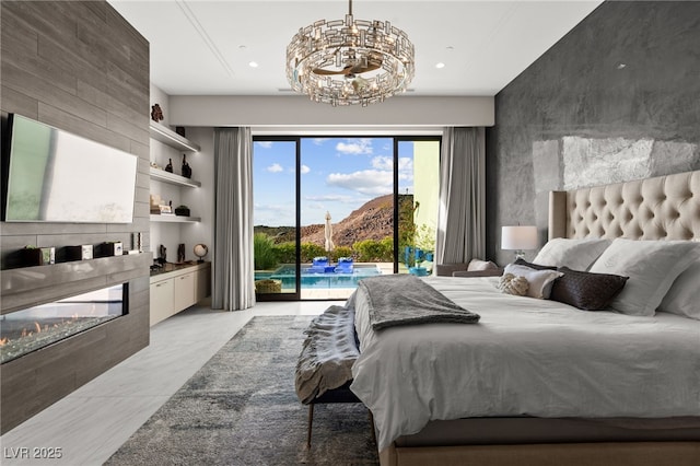 387 Solitude Peak Ln, Henderson, NV 89012 - bedroom featuring access to outside, an inviting chandelier, a large fireplace, marble finish floor, and a mountain view