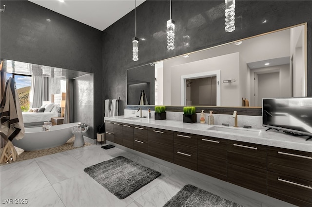 387 Solitude Peak Ln, Henderson, NV 89012 - full bathroom with a sink, a soaking tub, double vanity, and a towering ceiling