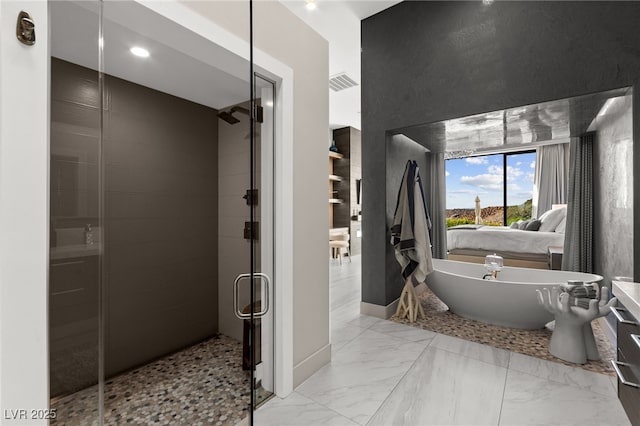 387 Solitude Peak Ln, Henderson, NV 89012 - full bathroom with visible vents, marble finish floor, a freestanding bath, and a shower stall