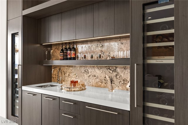 387 Solitude Peak Ln, Henderson, NV 89012 - bar featuring backsplash, wet bar, and a sink