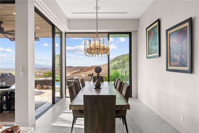 387 Solitude Peak Ln, Henderson, NV 89012 - dining room with baseboards, a notable chandelier, a wealth of natural light, and marble finish floor
