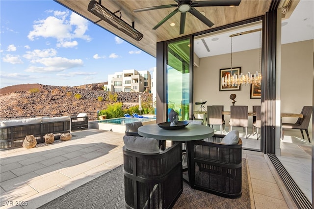 387 Solitude Peak Ln, Henderson, NV 89012 - view of patio with ceiling fan, a fenced in pool, a mountain view, and outdoor dining space