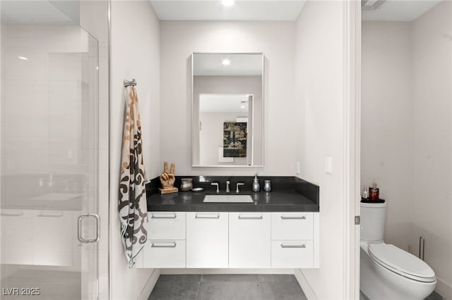 387 Solitude Peak Ln, Henderson, NV 89012 - bathroom with vanity, toilet, tile patterned flooring, and a stall shower