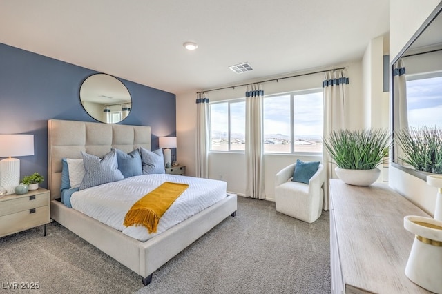 carpeted bedroom featuring visible vents