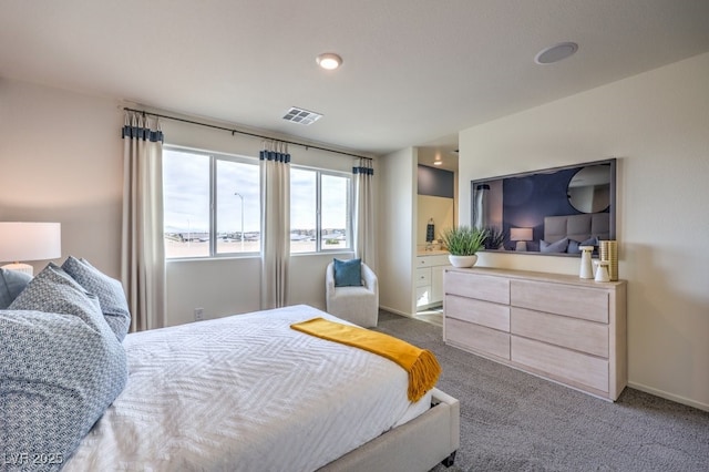 carpeted bedroom with visible vents and baseboards