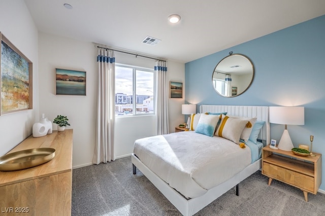 carpeted bedroom featuring baseboards and visible vents