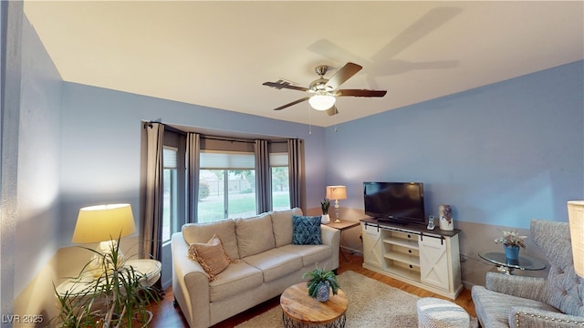 living room with ceiling fan and wood finished floors