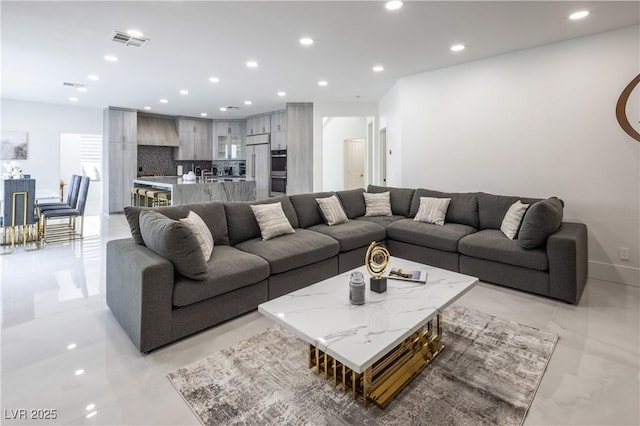 living area with recessed lighting and baseboards