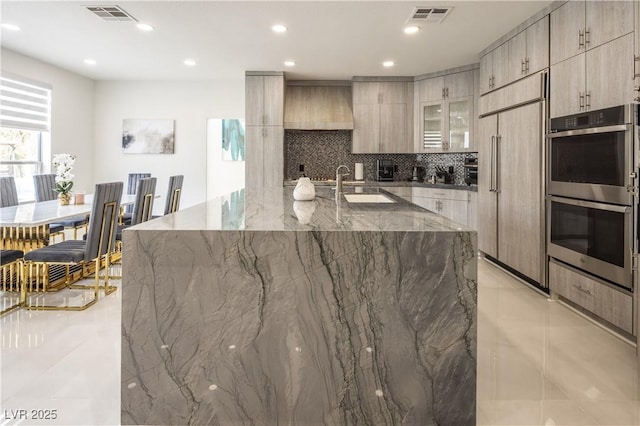 8000 Clock Tower Ct, Las Vegas, NV 89117 - kitchen featuring modern cabinets, tasteful backsplash, double oven, stone counters, and recessed lighting